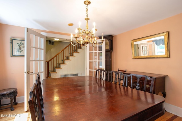 367 N Plain Rd, Great Barrington, MA 01236 - dining area with stairway, an inviting chandelier, wood finished floors, visible vents, and baseboards