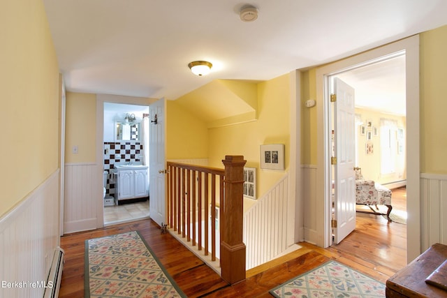 367 N Plain Rd, Great Barrington, MA 01236 - hallway featuring a baseboard heating unit, hardwood / wood-style flooring, a wainscoted wall, and an upstairs landing