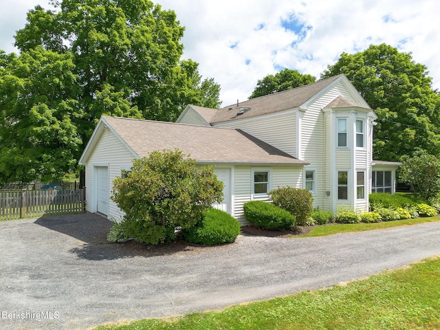 367 N Plain Rd, Great Barrington, MA 01236 - view of side of home featuring gravel driveway, fence, a shingled roof, and a garage