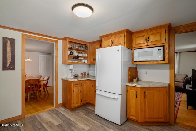 160 Marion Ave, North Adams, MA 01247 - kitchen with white appliances, light wood-style floors, open shelves, and brown cabinets