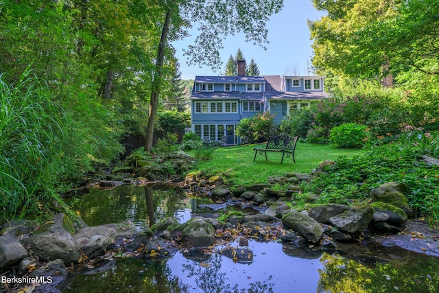 exterior space featuring a water view and a front yard