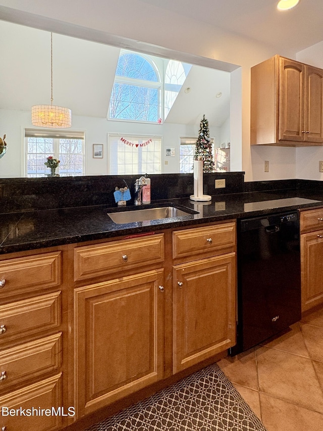 kitchen featuring sink, black dishwasher, pendant lighting, dark stone counters, and vaulted ceiling