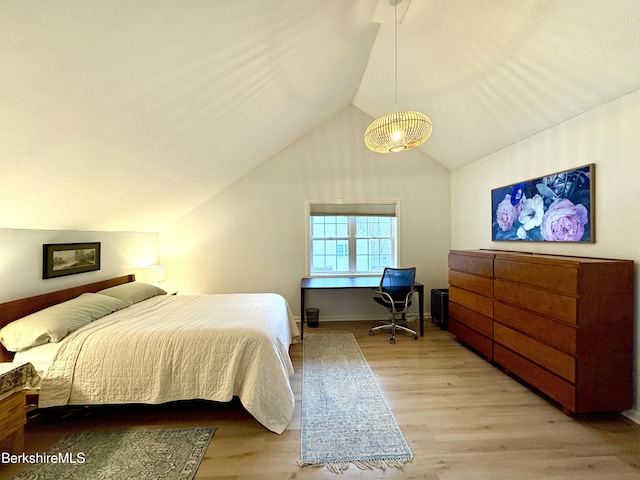 bedroom with vaulted ceiling and light hardwood / wood-style flooring