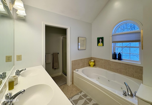 bathroom featuring tile patterned flooring, vanity, lofted ceiling, and plus walk in shower