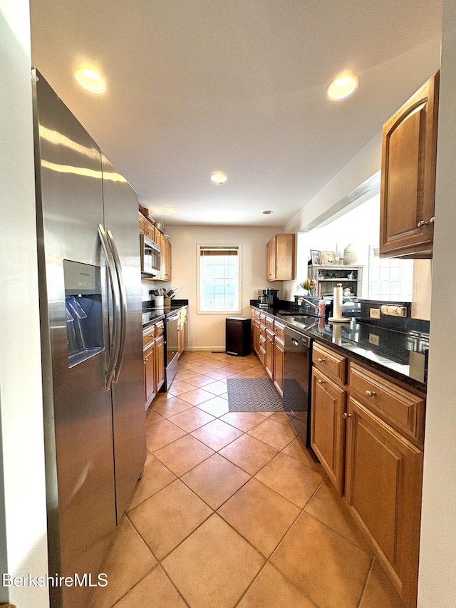 kitchen featuring light tile patterned floors and stainless steel appliances