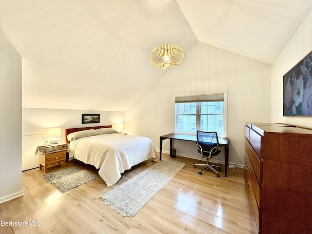 bedroom with light hardwood / wood-style flooring and lofted ceiling