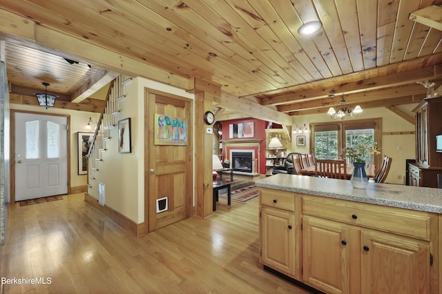 169 Jacobs Hollow Rd, Becket, MA 01223 - kitchen featuring a wood ceiling with exposed beams, light wood-type flooring, a fireplace, open floor plan, and pendant lighting