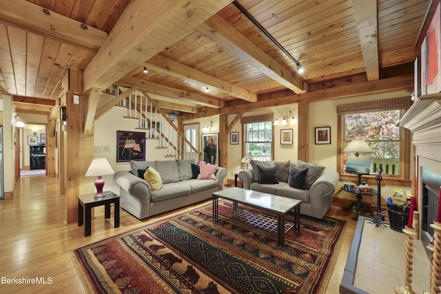 169 Jacobs Hollow Rd, Becket, MA 01223 - living area with stairs, a wood ceiling with exposed beams, light wood-type flooring, and a fireplace