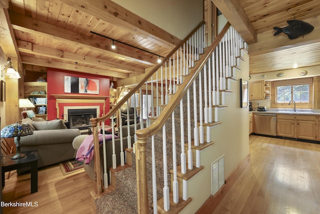 169 Jacobs Hollow Rd, Becket, MA 01223 - stairway featuring a wood ceiling with exposed beams, wood finished floors, and a fireplace
