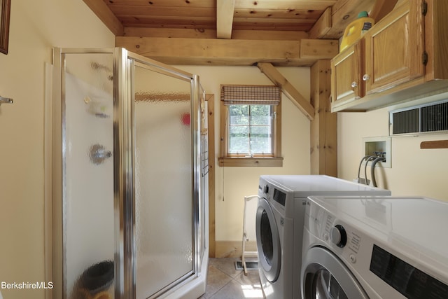 169 Jacobs Hollow Rd, Becket, MA 01223 - laundry room featuring washer and dryer, wooden ceiling, light tile patterned floors, and cabinet space