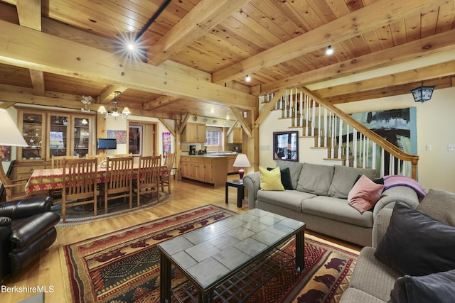 169 Jacobs Hollow Rd, Becket, MA 01223 - living room featuring a chandelier, light wood-style floors, a wood ceiling with exposed beams, and stairs