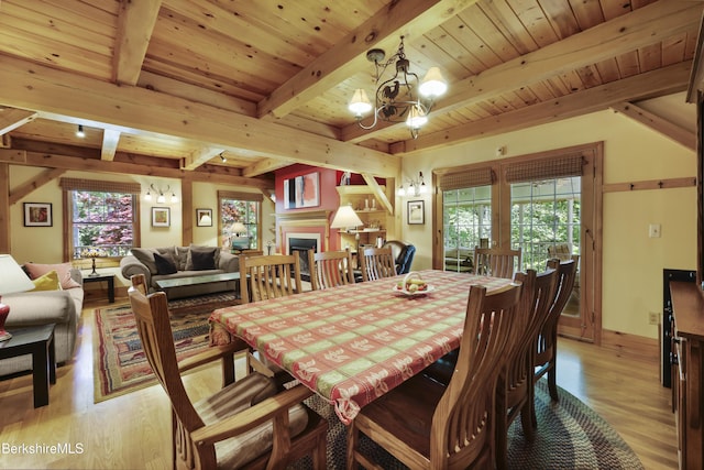 169 Jacobs Hollow Rd, Becket, MA 01223 - dining area featuring light wood-style floors, a chandelier, a wood ceiling with exposed beams, and a fireplace