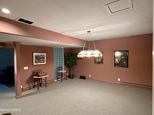 interior space featuring carpet flooring, visible vents, a baseboard heating unit, and baseboards