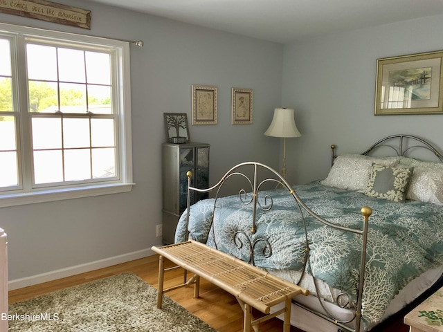 bedroom featuring baseboards and wood finished floors