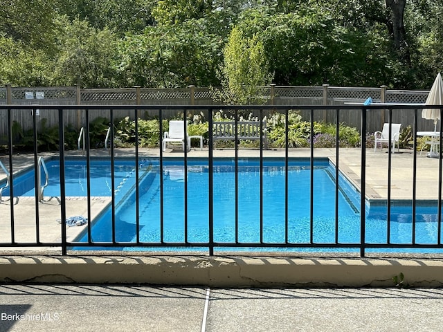 view of pool with a fenced in pool and fence
