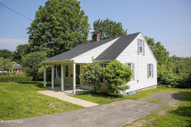 153 State Rd, Great Barrington, MA 01230 - view of front of house with a front lawn, a chimney, and a shingled roof