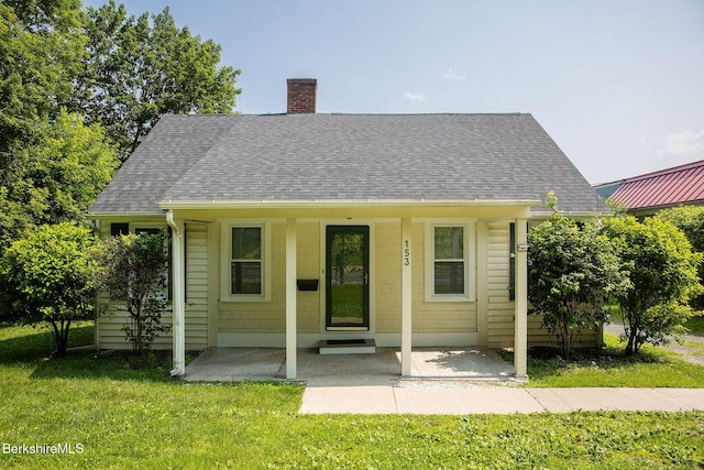 153 State Rd, Great Barrington, MA 01230 - view of front of house featuring a chimney, a front lawn, a shingled roof, and a porch