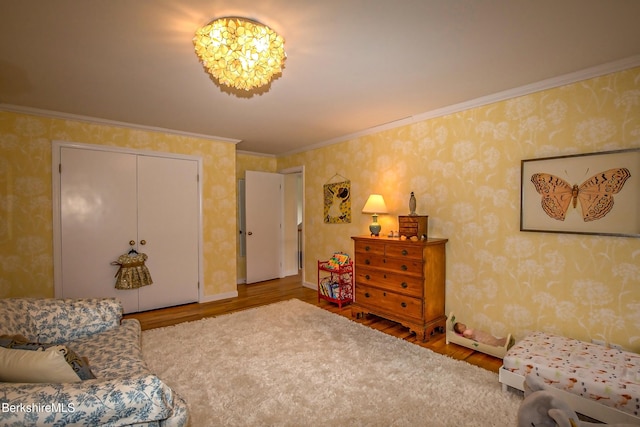 1136 Barker Rd Unit 65, Pittsfield, MA 01201 - bedroom with wood finished floors, wallpapered walls, ornamental molding, and a closet
