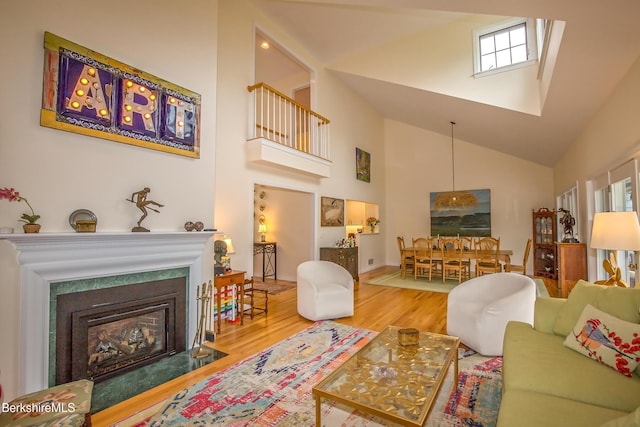 1136 Barker Rd Unit 65, Pittsfield, MA 01201 - living room with high vaulted ceiling, wood finished floors, and a fireplace with flush hearth
