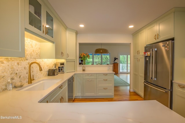 1136 Barker Rd Unit 65, Pittsfield, MA 01201 - kitchen featuring stainless steel appliances, light countertops, tasteful backsplash, light wood-style floors, and recessed lighting