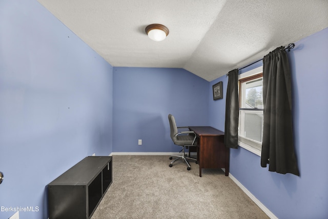 office space featuring light carpet, a textured ceiling, lofted ceiling, and baseboards