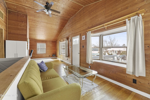 living room with vaulted ceiling, hardwood / wood-style floors, wooden ceiling, and wooden walls