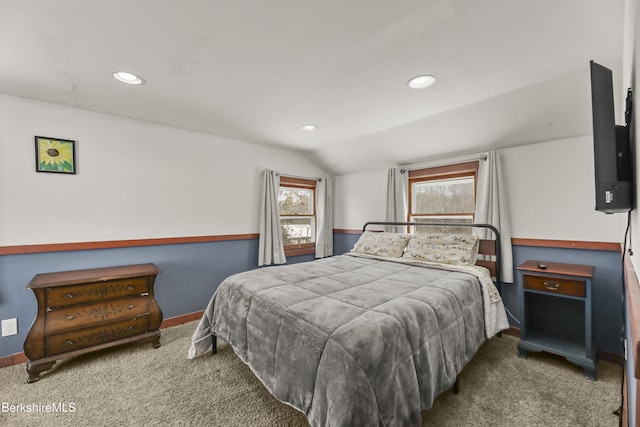 bedroom featuring baseboards, multiple windows, vaulted ceiling, and carpet flooring