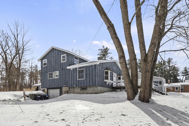 view of front of home with an attached garage and board and batten siding