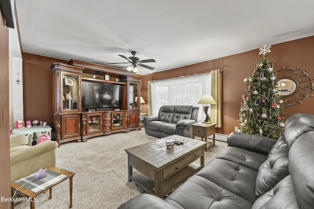 carpeted living room with ceiling fan and a baseboard heating unit