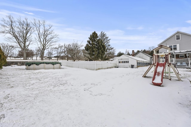 snowy yard with a playground