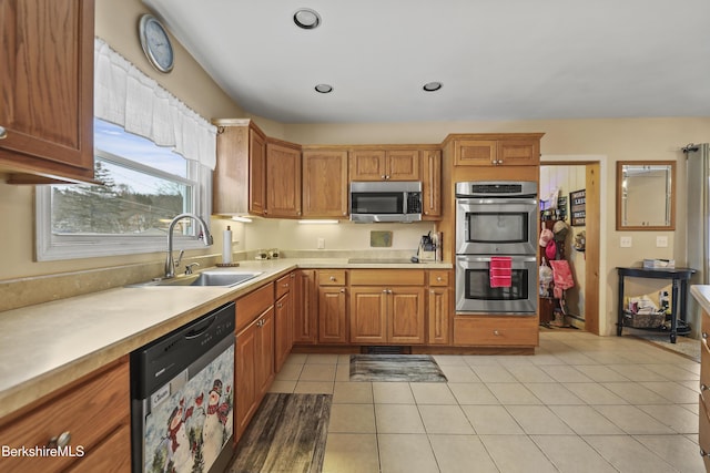 kitchen with sink, light tile patterned floors, and appliances with stainless steel finishes