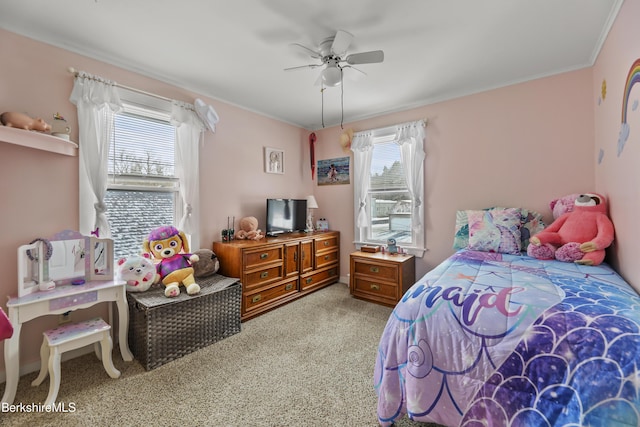 carpeted bedroom featuring ceiling fan and crown molding