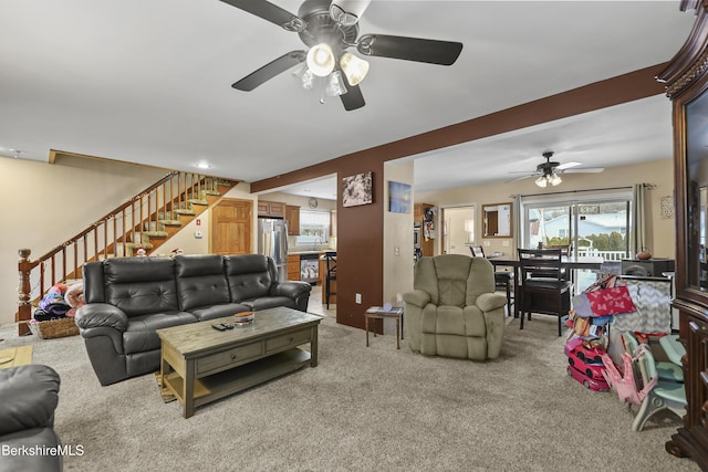 carpeted living room featuring ceiling fan