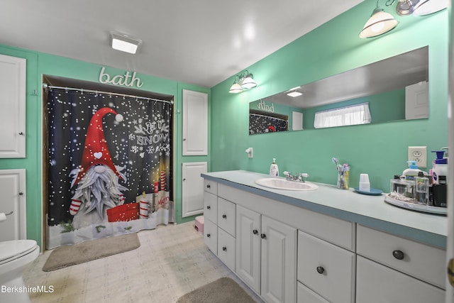 bathroom featuring vanity, curtained shower, and toilet