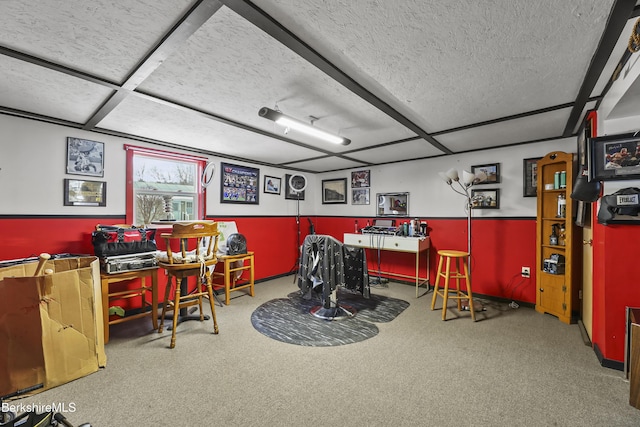 recreation room featuring carpet and a textured ceiling