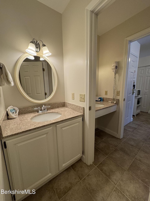 bathroom with vanity and tile patterned flooring