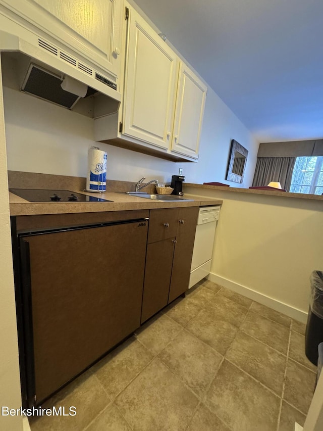 kitchen with black electric cooktop, sink, white cabinets, and white dishwasher