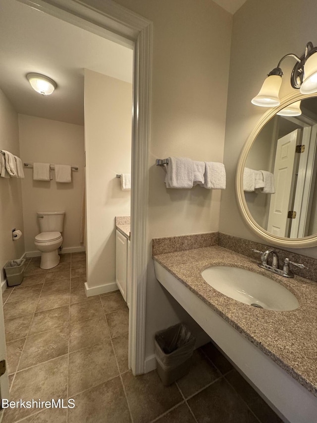 bathroom featuring toilet and vanity