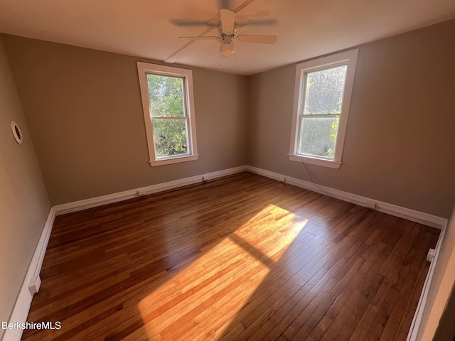 unfurnished room featuring dark hardwood / wood-style floors and ceiling fan