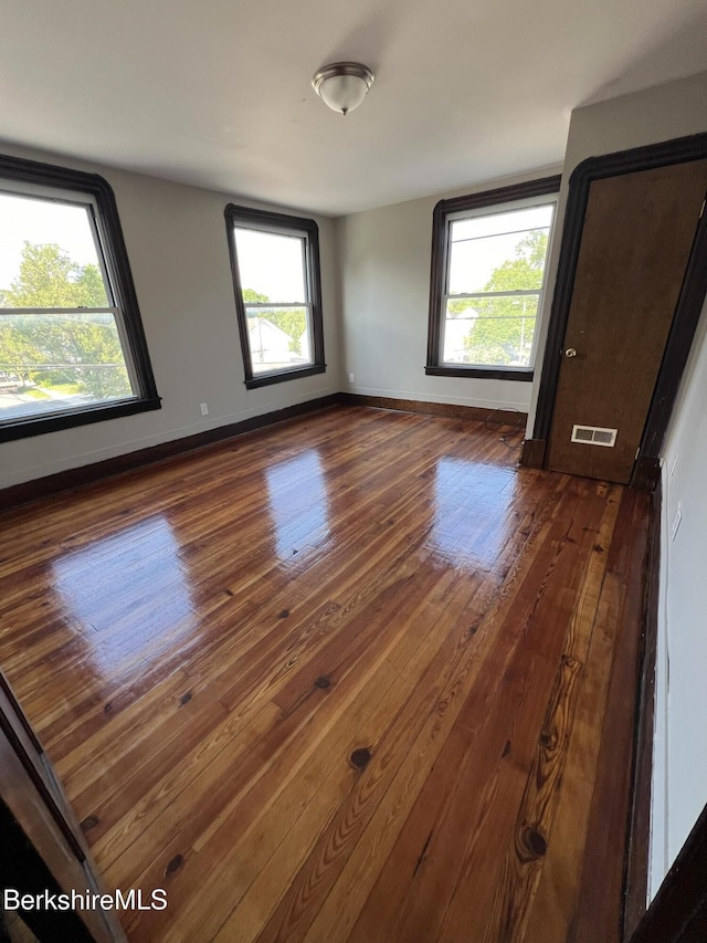 spare room with dark wood-type flooring