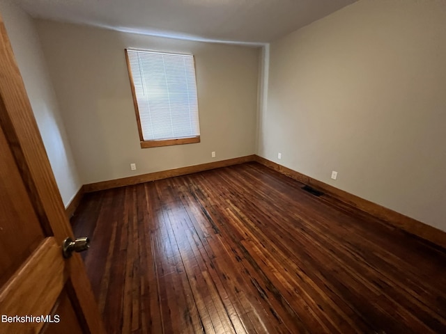 empty room featuring dark wood-type flooring