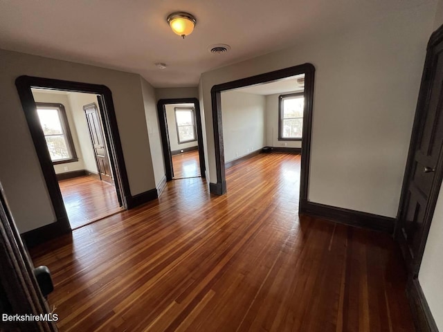 empty room with dark hardwood / wood-style floors