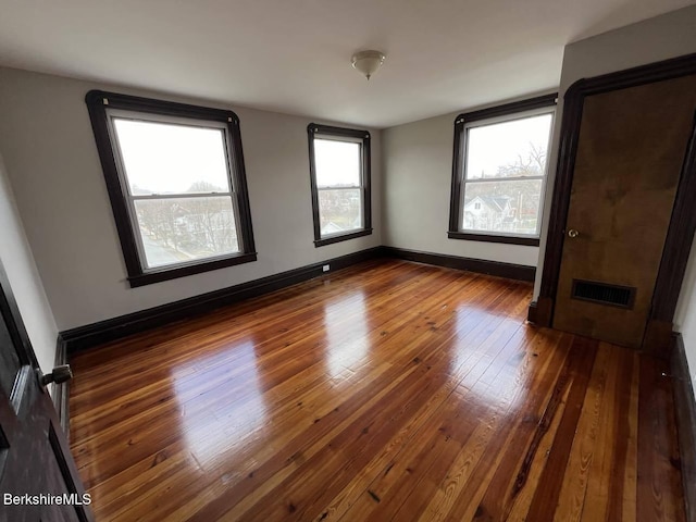 unfurnished bedroom with dark hardwood / wood-style flooring