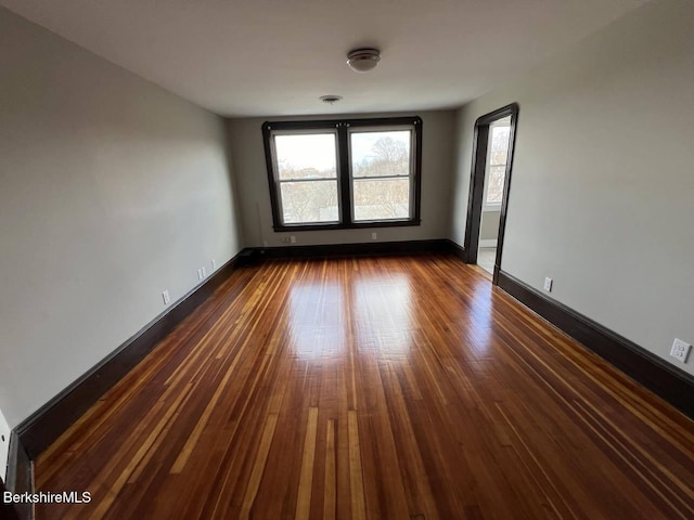 spare room featuring dark hardwood / wood-style flooring