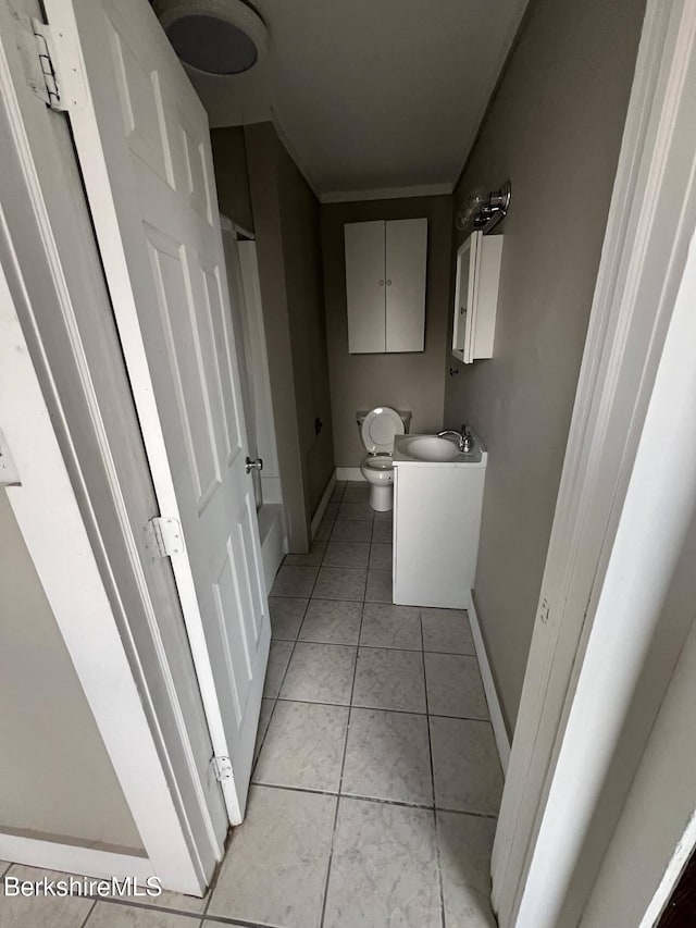 bathroom with vanity, tile patterned floors, and toilet