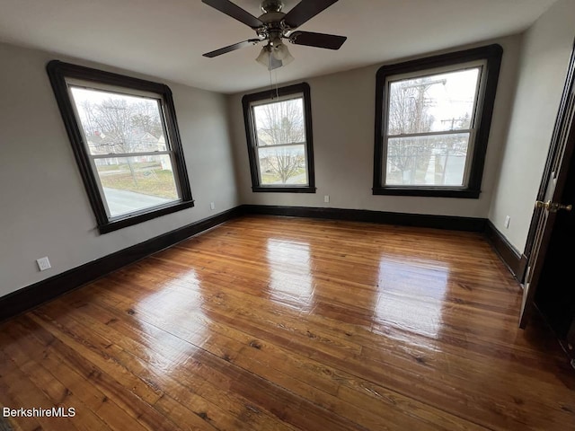 spare room with ceiling fan and wood-type flooring