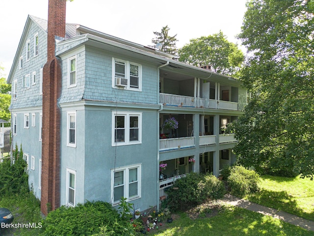6-10 Manville St, Great Barrington, MA 01230 - back of house featuring a balcony, cooling unit, a chimney, and stucco siding