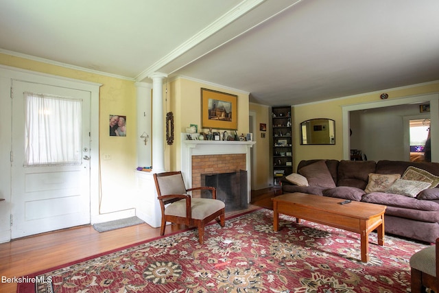 6-10 Manville St, Great Barrington, MA 01230 - living area with wood finished floors, a fireplace, ornate columns, and ornamental molding