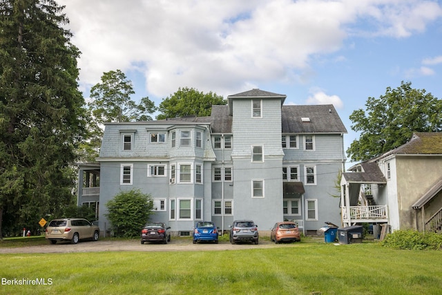 6-10 Manville St, Great Barrington, MA 01230 - rear view of house with a lawn, uncovered parking, and stucco siding