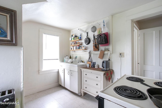 6-10 Manville St, Great Barrington, MA 01230 - kitchen with white electric range oven, light countertops, open shelves, and lofted ceiling
